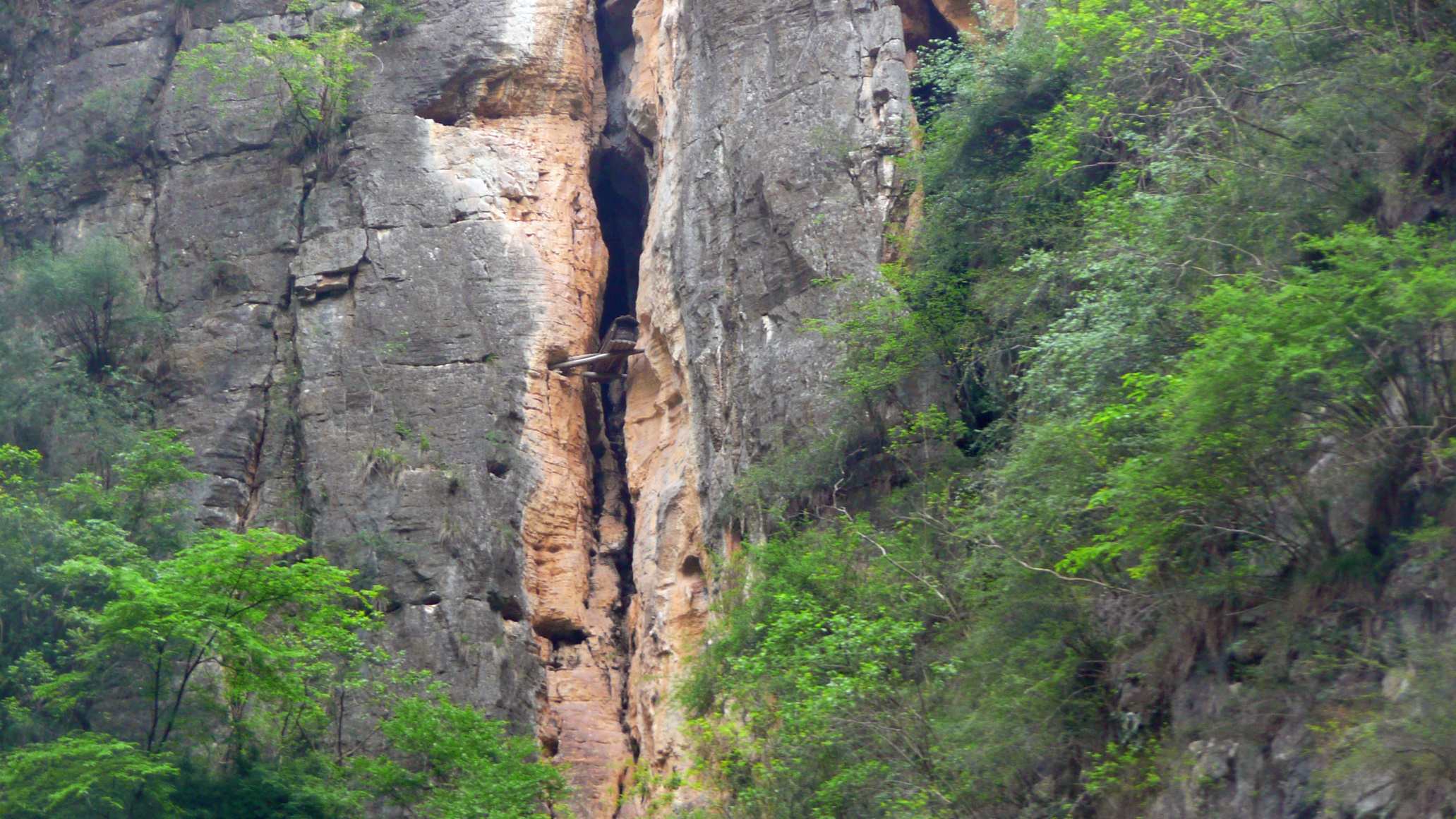 A coffin hangs precariously on a cliff face at the Shen Nong Stream, Hubei, China