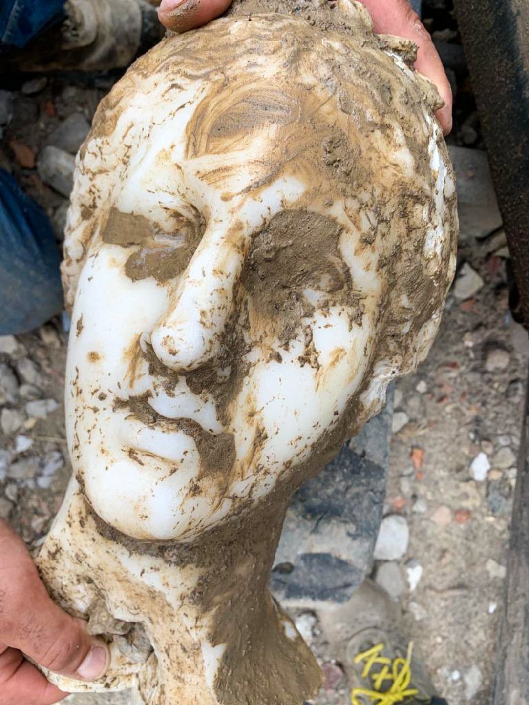 Ancient white marble head, possibly of Aphrodite, unearthed in Italy's Rome