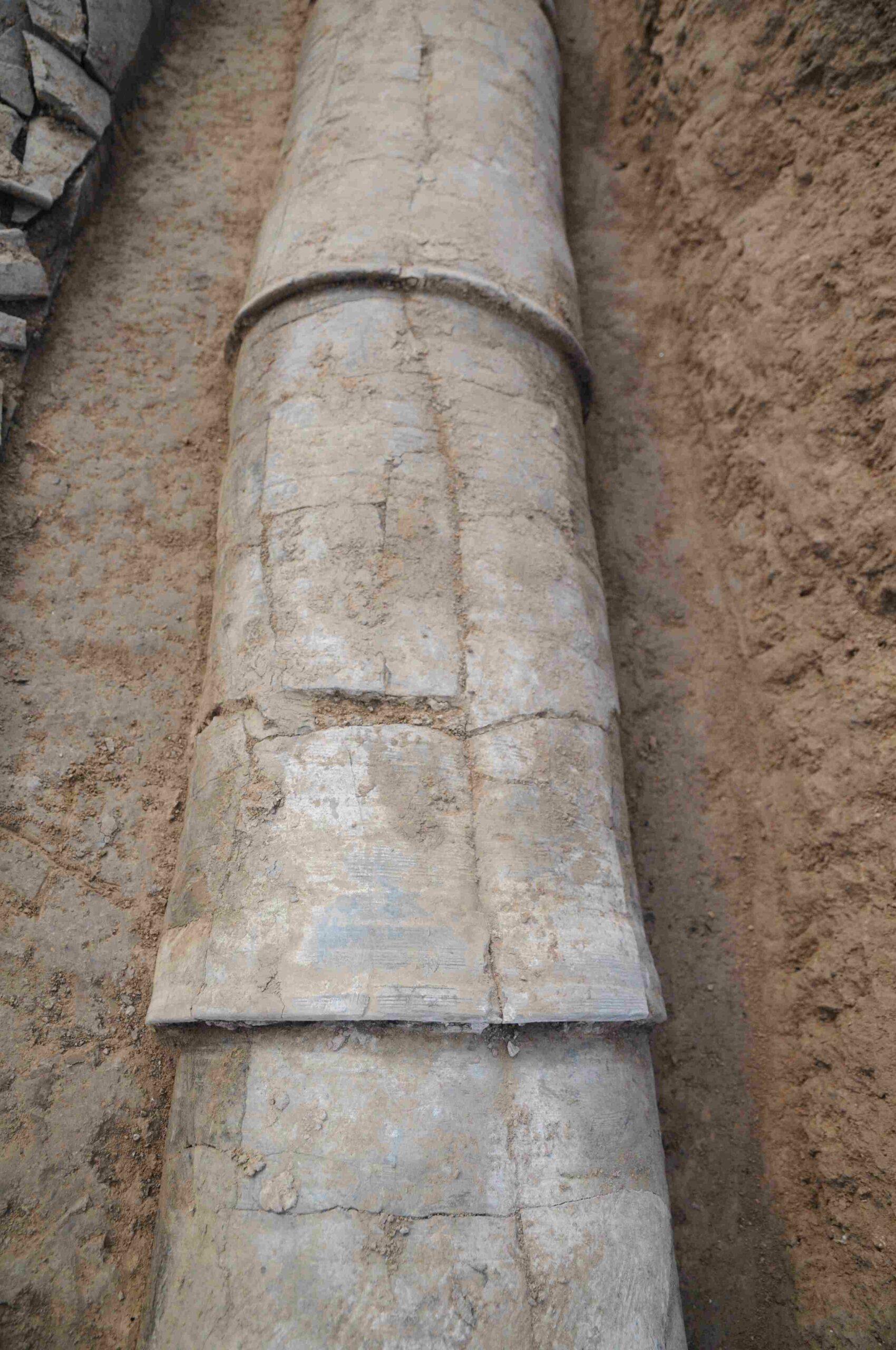 Closeup photo of water pipe segments fitted together in situ at Pingliangtai. 